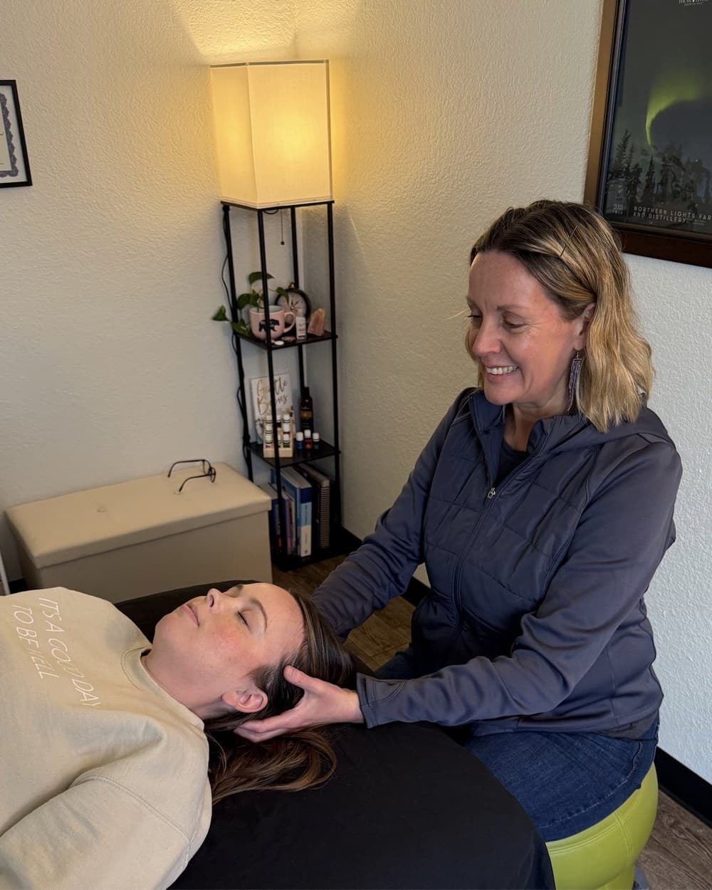 Andrea performing a craniosacral therapy session on a client